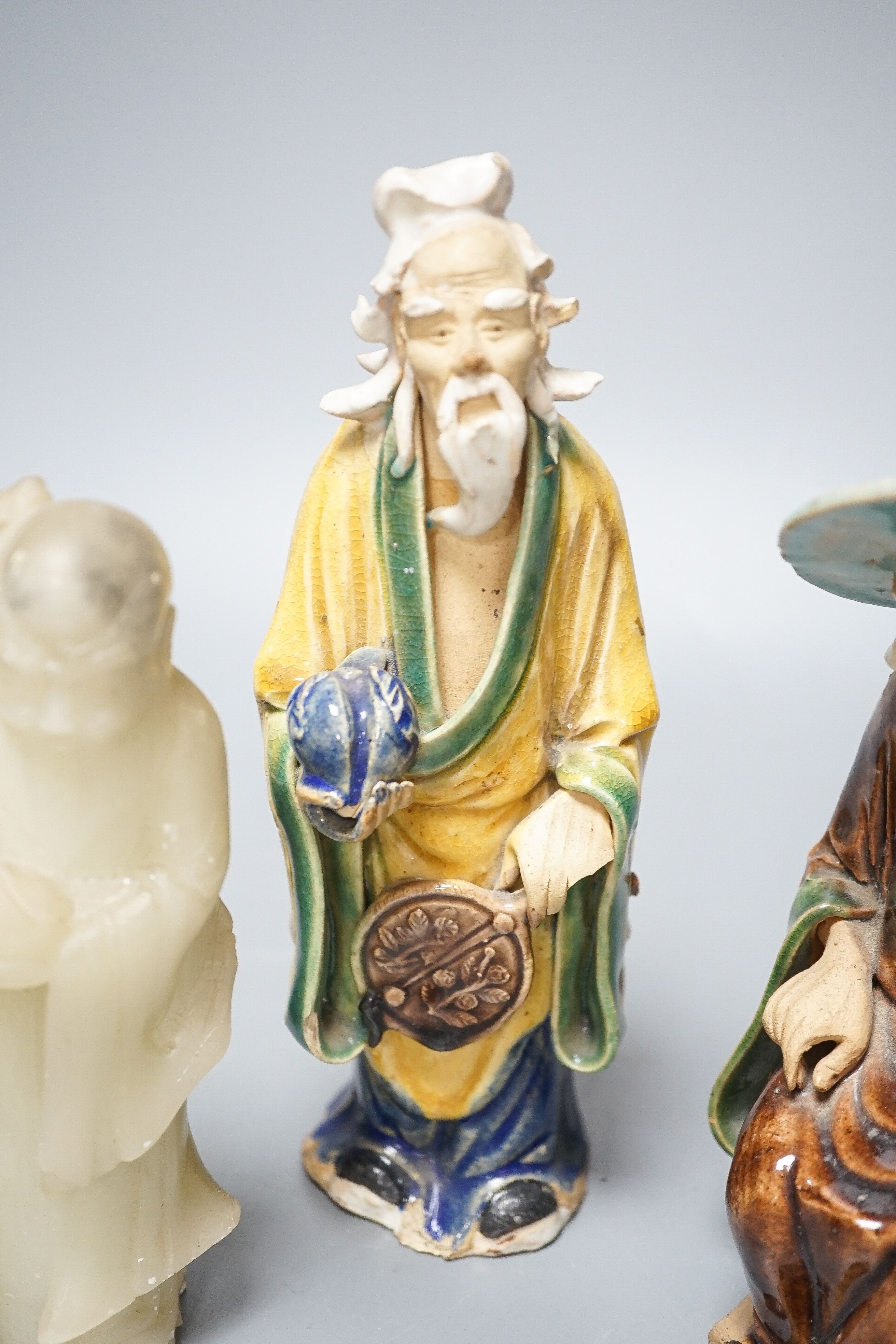 A Chinese glazed biscuit lion-dog seal, a Chinese blue and white tureen, width 18cm, two Shiwan figures and two teabowls, four saucers and a soapstone carving 20cm